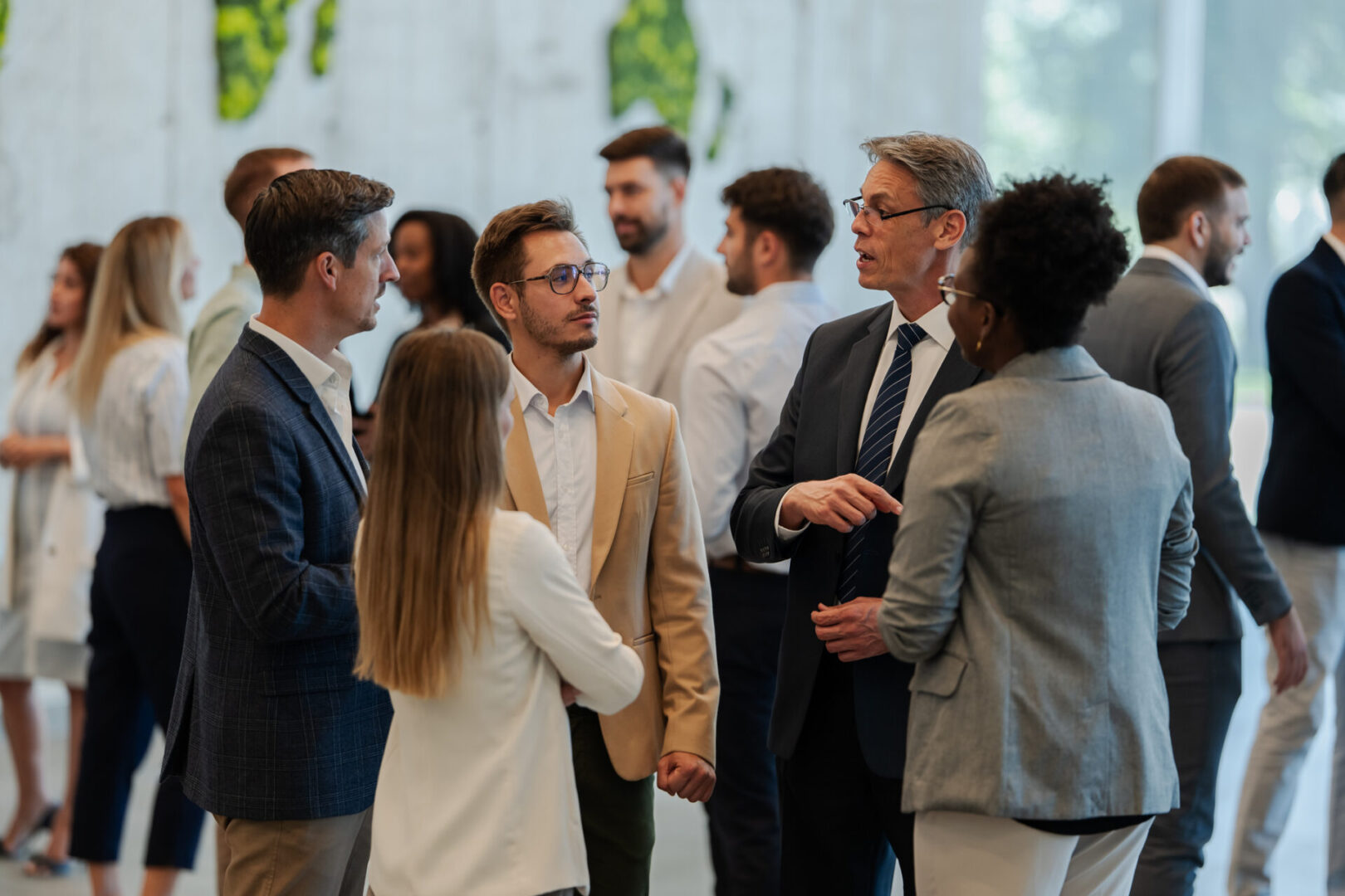 Professionals gathered, engaging in conversations and exchanging ideas at a corporate conference or seminar